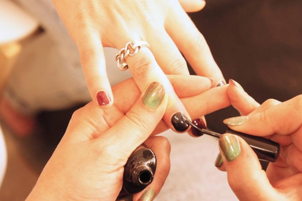 Nail art being painted in a salon