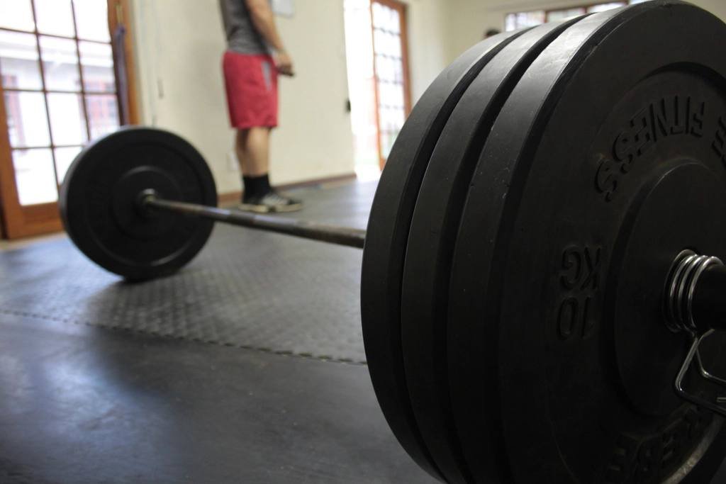 A loaded barbell on a gym floor