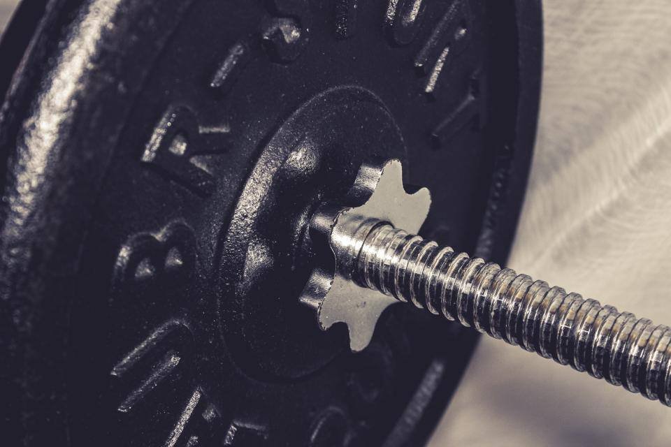 A close-up of a barbell and plate