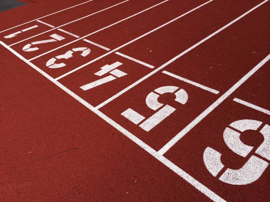 Numbered starting lanes on a red track