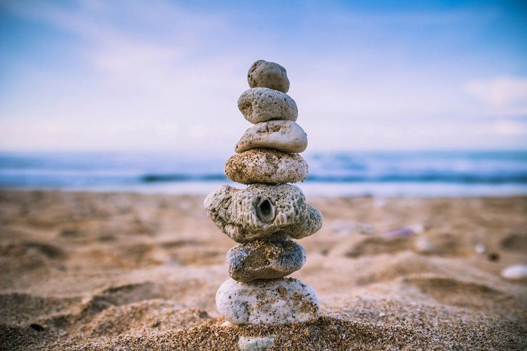 A stack of balanced stones on a beach