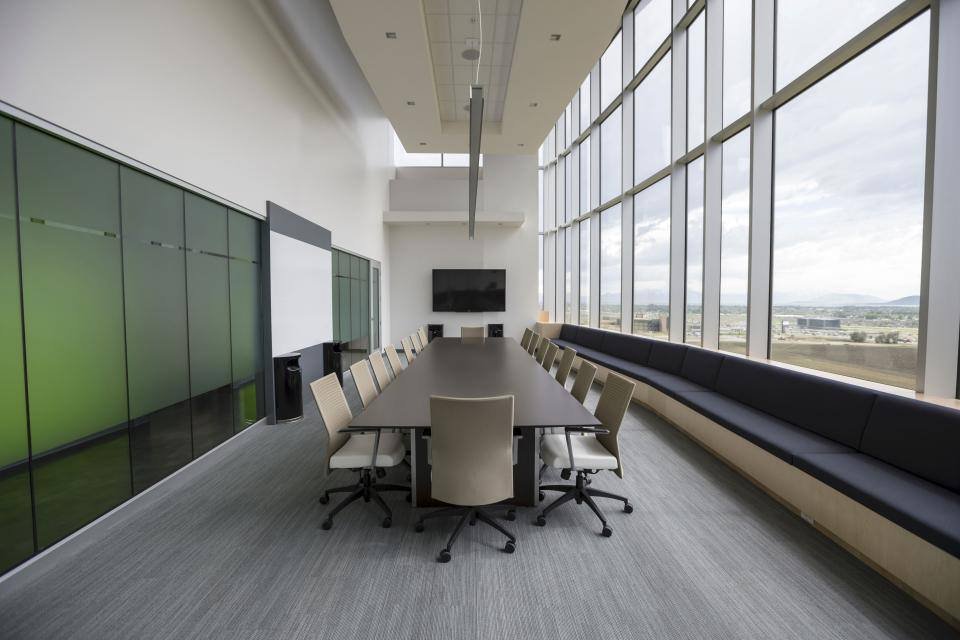 An empty boardroom with a long table