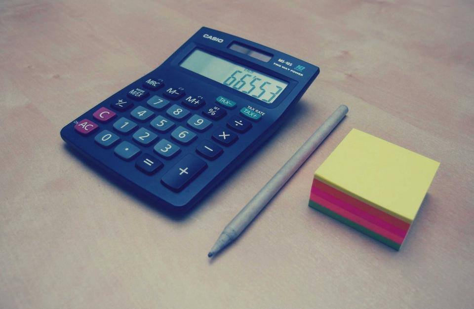 A blue calculator and sticky notes