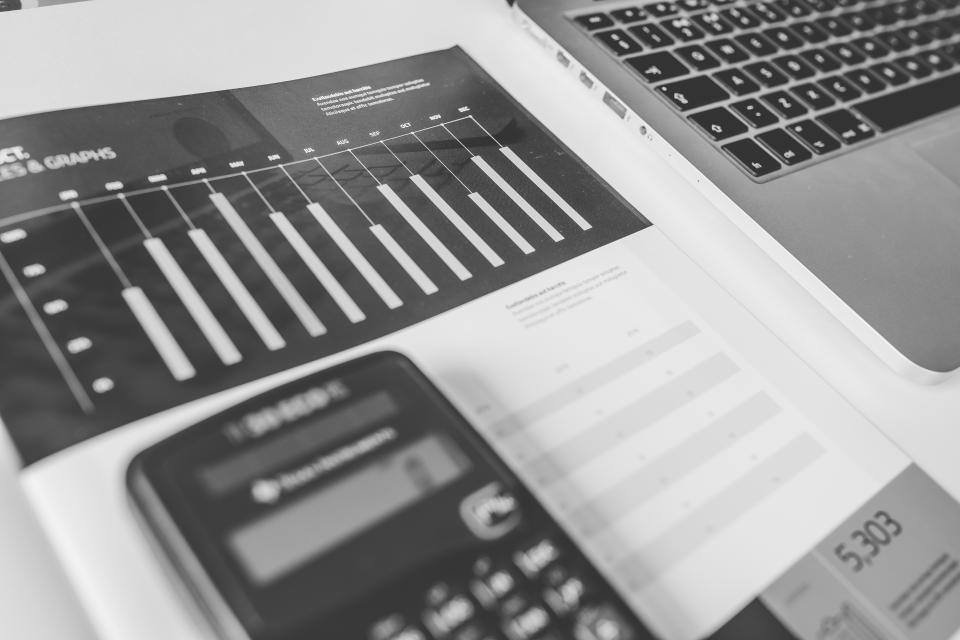 A calculator on printed financial charts