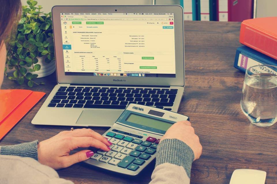 A laptop and calculator on a desk