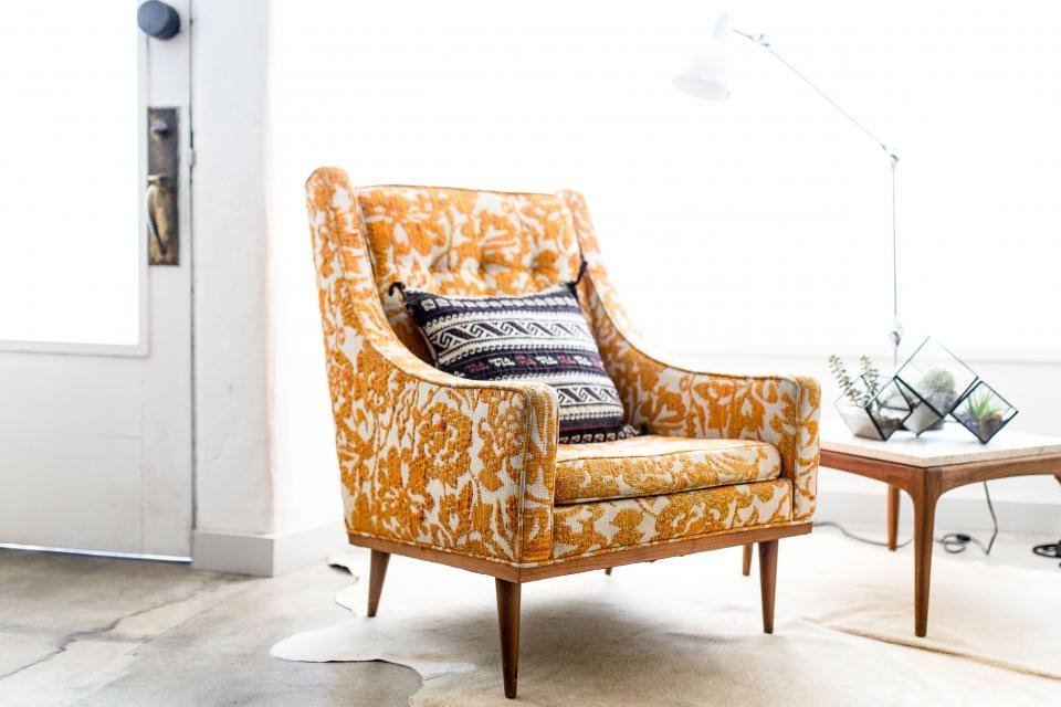 A patterned armchair in a bright room
