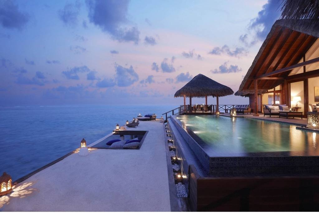 An infinity pool over the sea at sunset