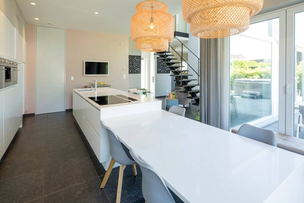 An open-plan kitchen with pendant lights