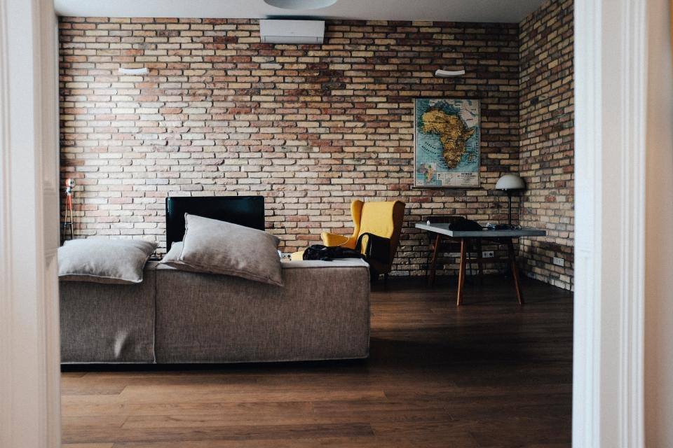 A loft living room with a brick wall
