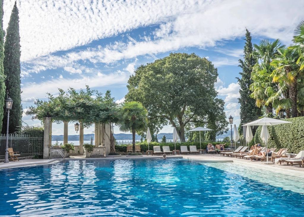 A resort pool surrounded by palm trees