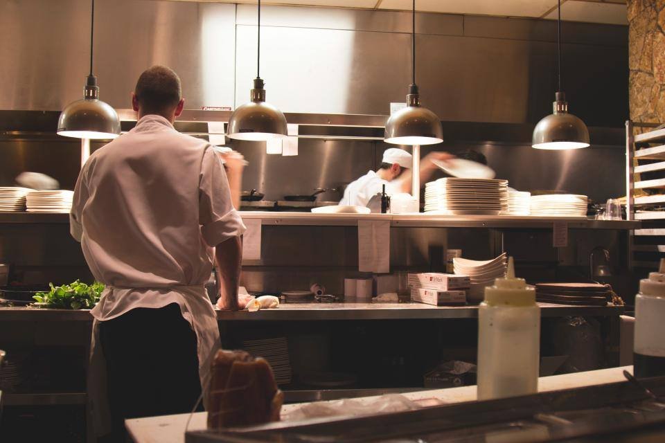 A chef working in a busy restaurant kitchen