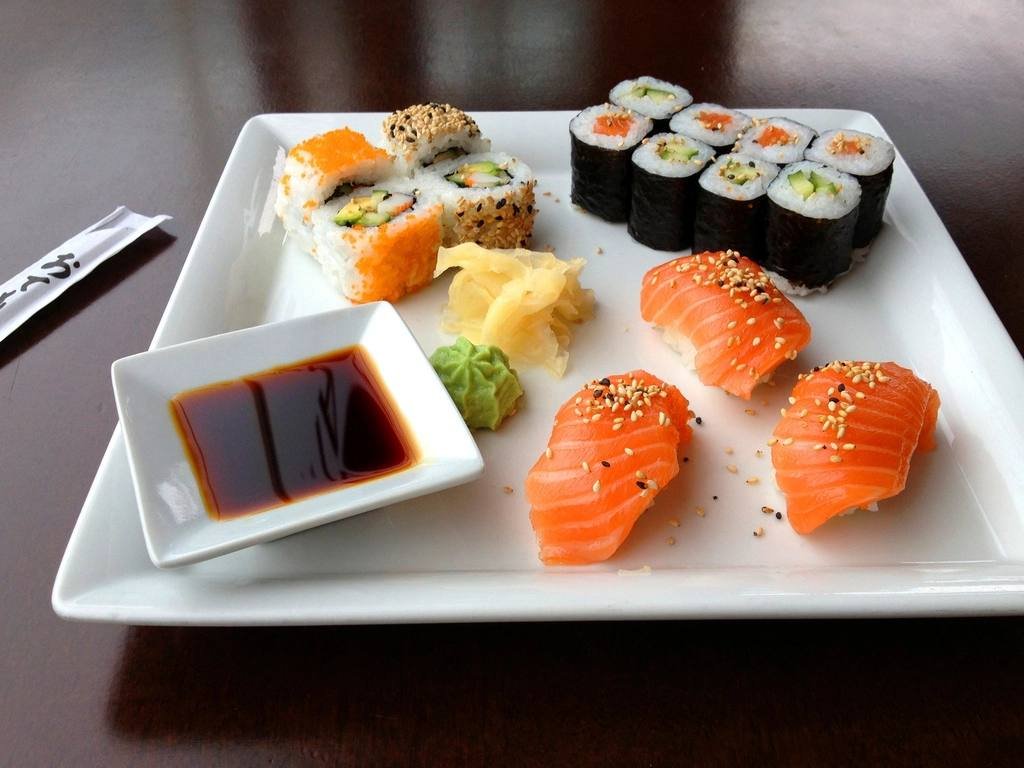Sushi and soy sauce on a white plate